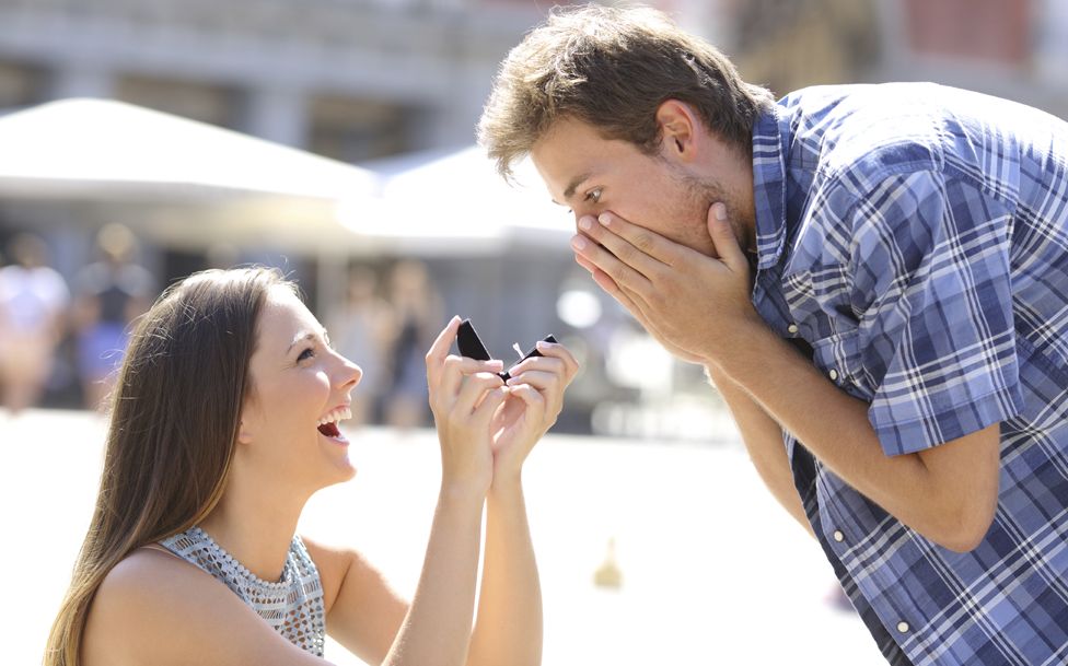 Stock image of a woman proposing to a man