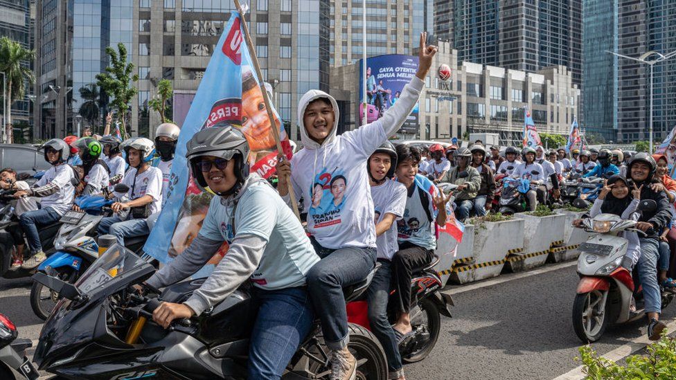A convoy of supporters of Indonesian Minister of Defense Prabowo Subianto poses for photos on the way to the quick count location at Istora Senayan on February 14, 2024 in Jakarta, Indonesia.