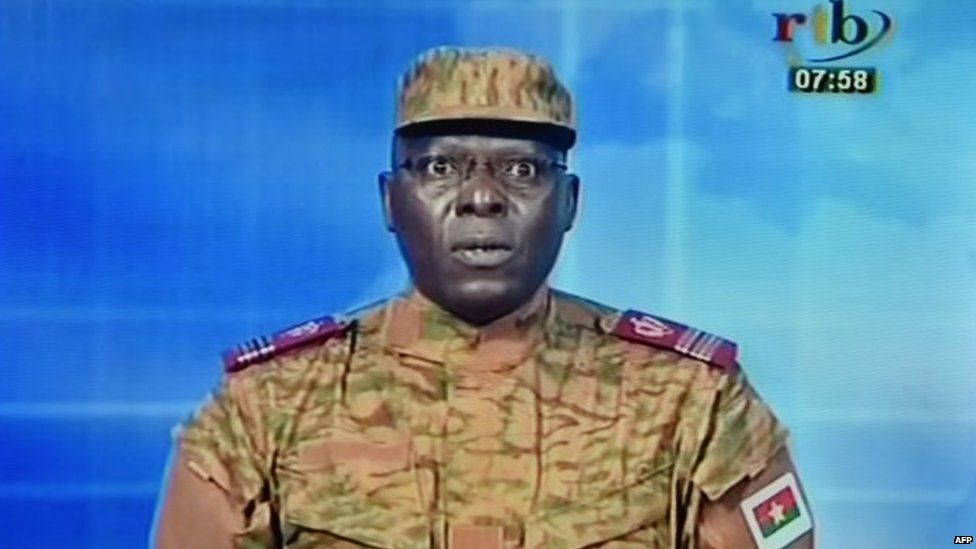 A picture taken on September 17, 2015 shows a TV screen during the broadcast of the speech of Lieutenant-colonel Mamadou Bamba announcing that a new "National Democratic Council" had put an end "to the deviant regime of transition"