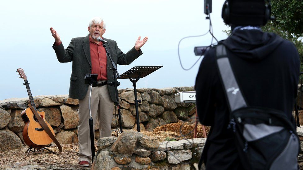 Pastor George Runyan gives a sermon during a sunrise Easter service at Mt Helix Park in San Diego, California, 12 April 2020