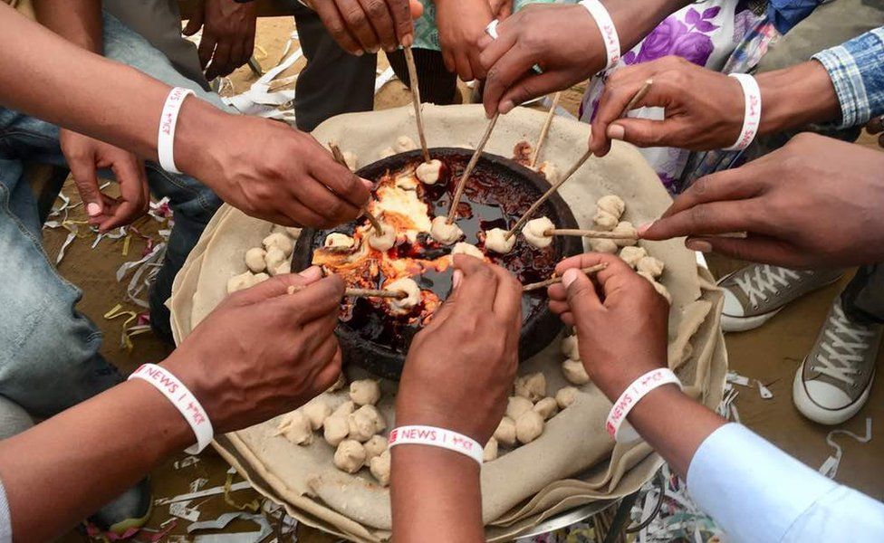 Guests use sticks to dip balls made from barley, called tihlo, into the dish usually served on special occasions.