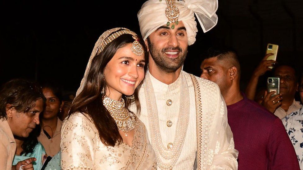 Bollywood actors Ranbir Kapoor (R) and Alia Bhatt pose for pictures during their wedding ceremony in Mumbai on April 14, 2022.