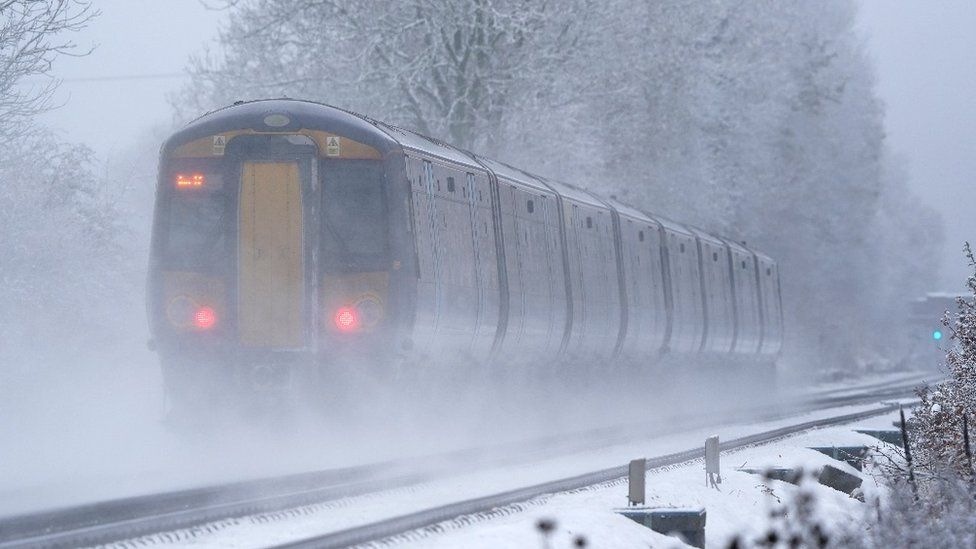 A South-eastern train makes its way through Ashford in Kent as rail services remain disrupted in the icy weather