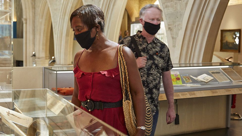 Museum visitors wearing masks