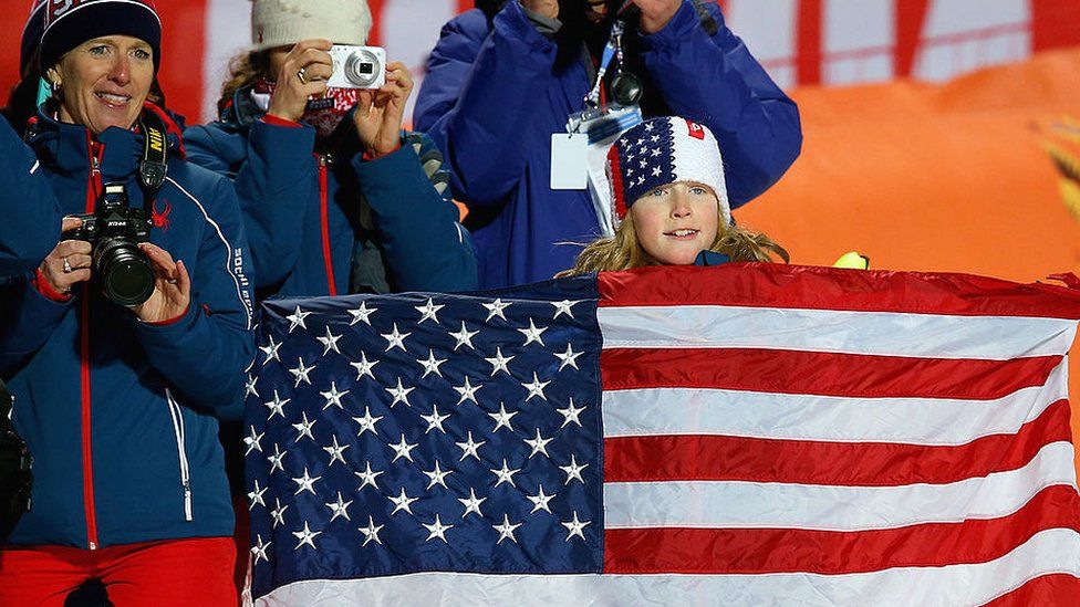 US family with flag at Sochi Olympics in Russia