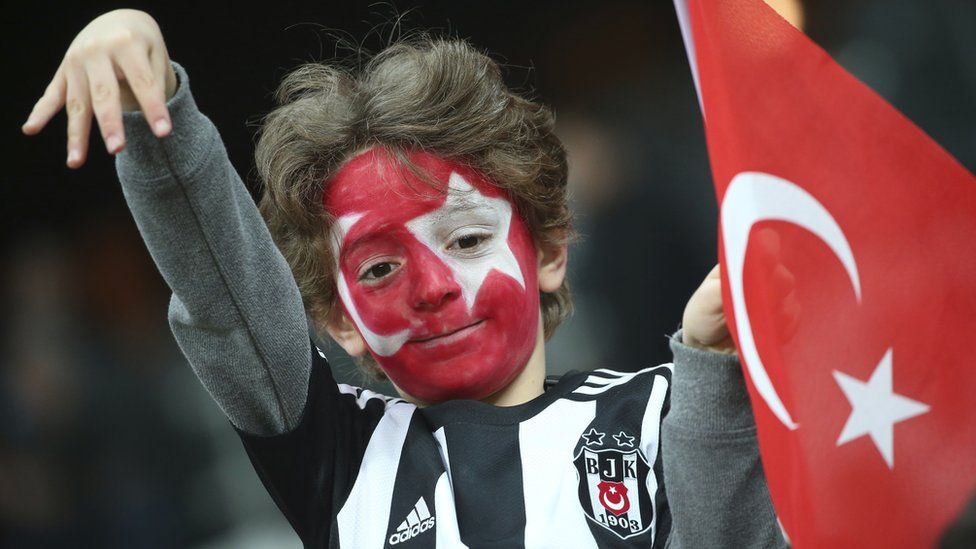 A Besiktas fan, his face painted with the colours of the Turkish flag, at the soccer match between Beisktas and Kayserispor, the first game since Saturday's twin attacks outside the stadium in Istanbul, 14 Wednesday 2016