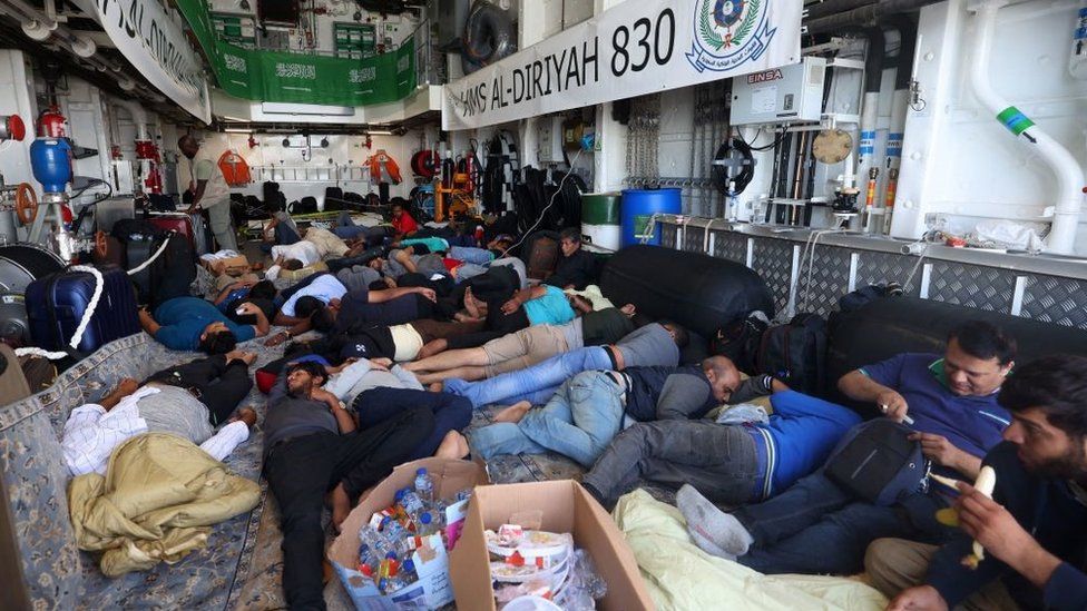 Evacuees rest onboard a Saudi vessel as it travels from Port Sudan to Jeddah on April 30, 2023