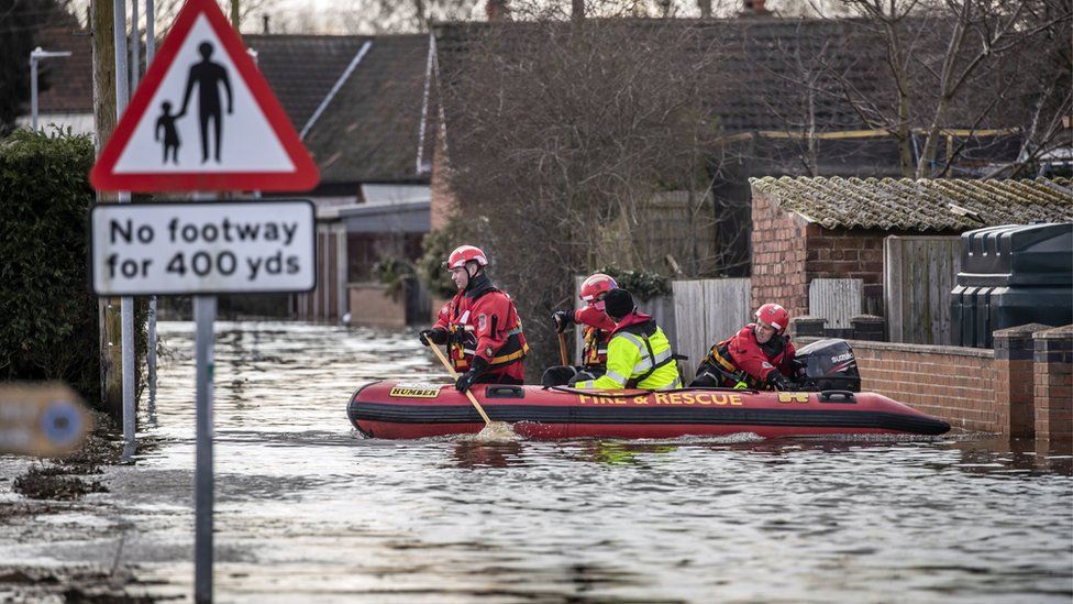 Rescue workers travelling by boat in East Cowick, Yorkshire