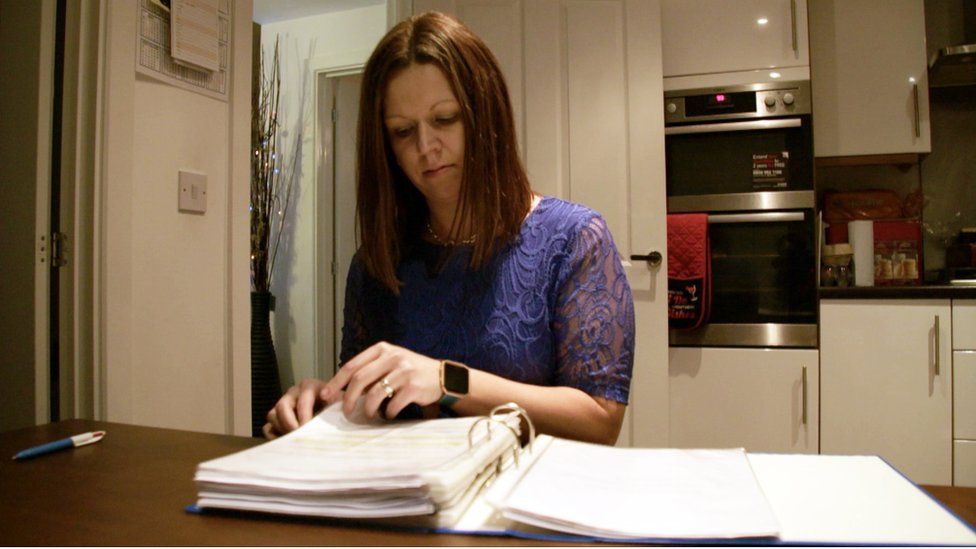 Katie Kendrick looking through paperwork