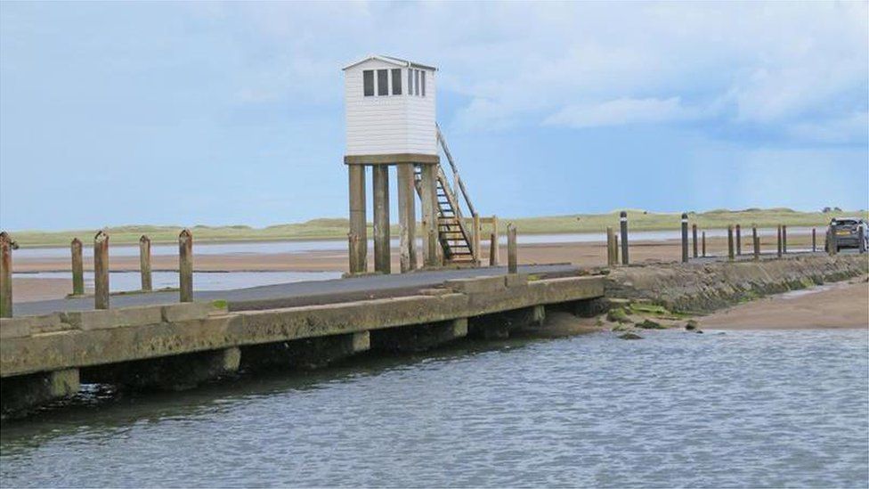 The newly refurbished Refuge Box at low tide on the Causeway