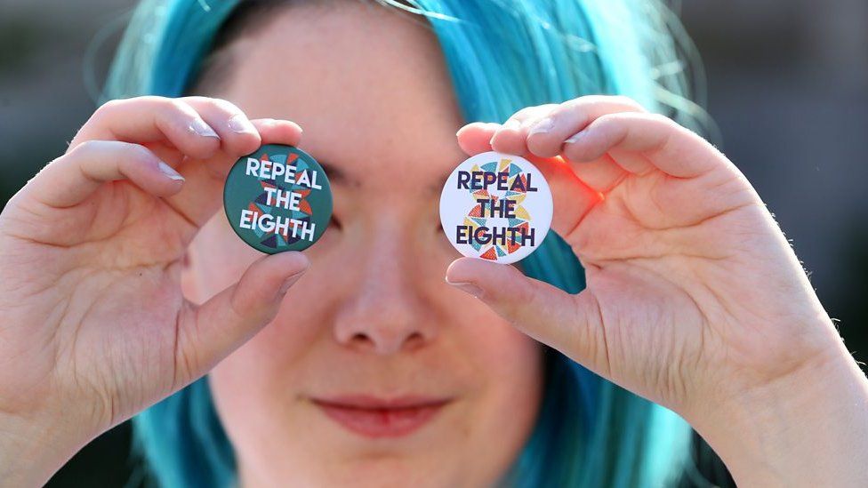 Protester with 'repeal the Eighth' badges