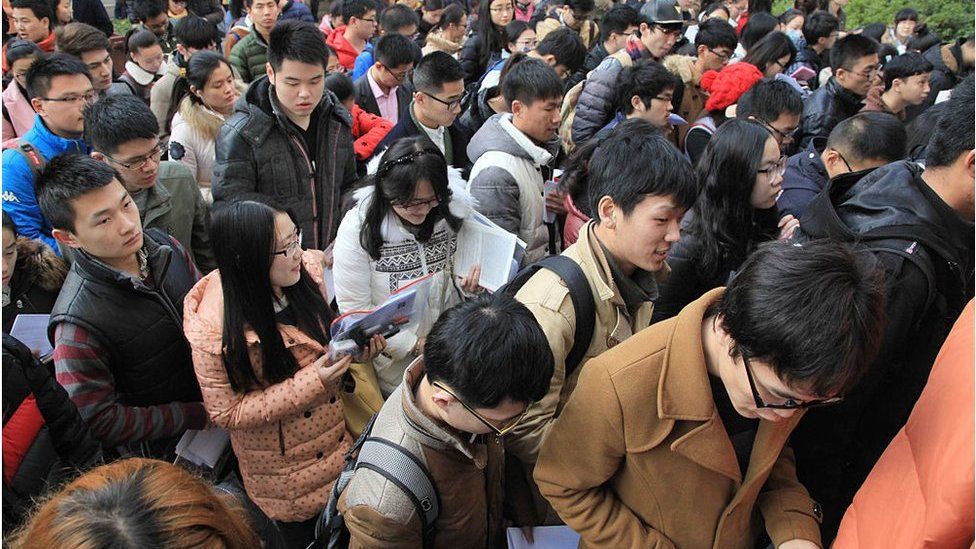 Candidates prepare outside the civil service examination room at Nanjing Forestry University on 29 November 2015 in Nanjing, Jiangsu Province of China. About 1.4 million people signed up for the civil service examination for 270,000 places this year.