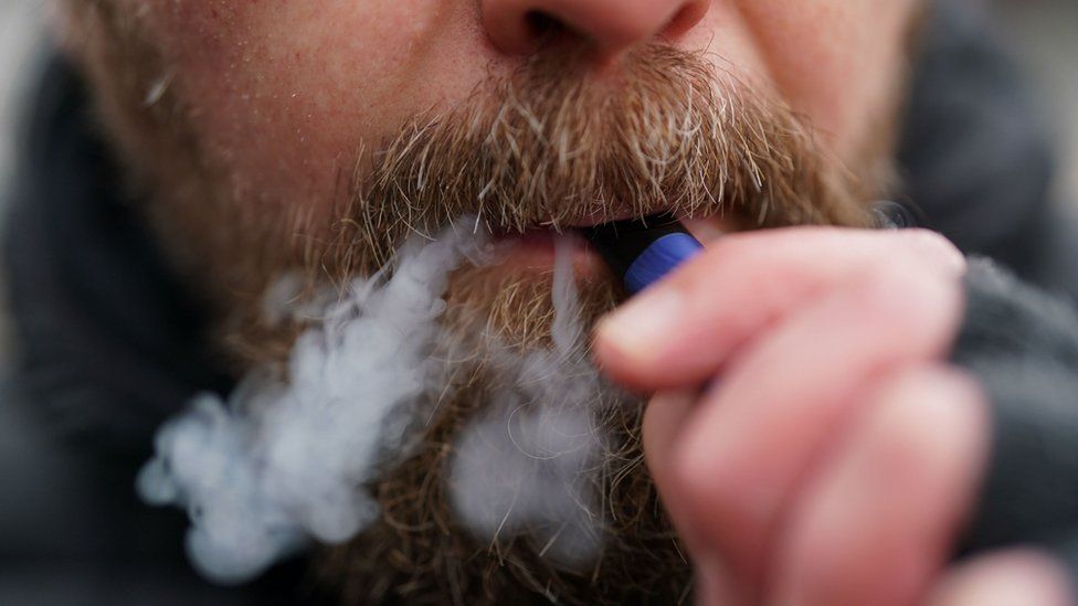 Man using a disposable vape