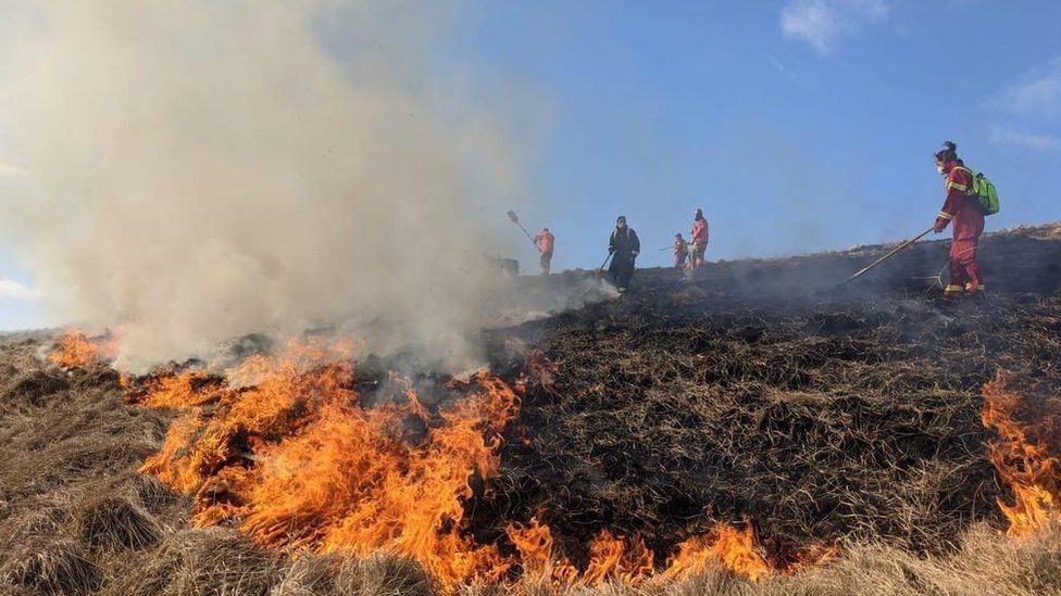 Firefighters tackling fire in the Peak District
