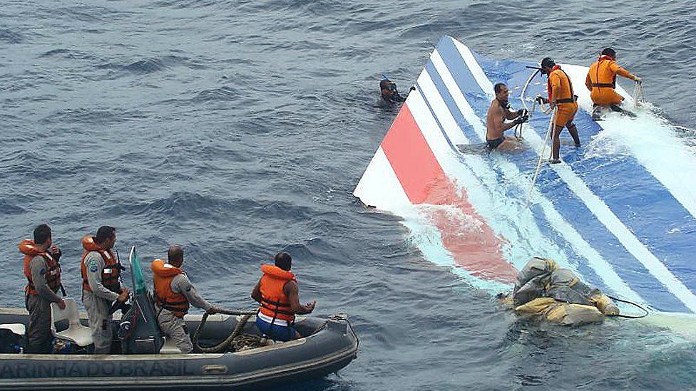 Handout image released on June 8, 2009 by the Brazilian Air Force (FAB) shows crew members preparing to tow a part of the wreckage of a Air Bus A330-200 jetliner