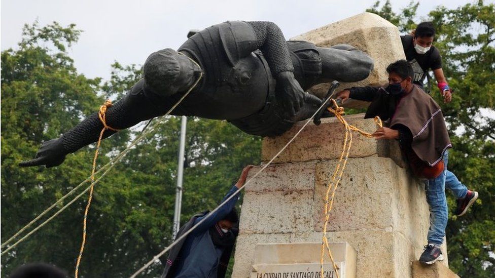 Protesters knock down the statue of the founder of the city, Spanish conqueror Sebastian de Belalcazar, during the protests against the tax reform called by the workers" centrals in Cali, Colombia, 28 April 2021