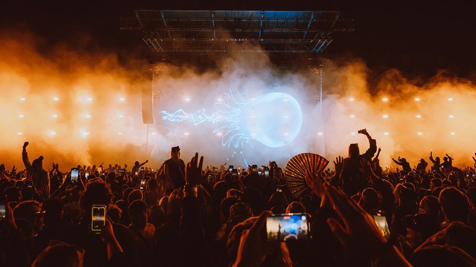 Film of a jellyfish plays on a big screen on stage in front of thousands of people at Parklife
