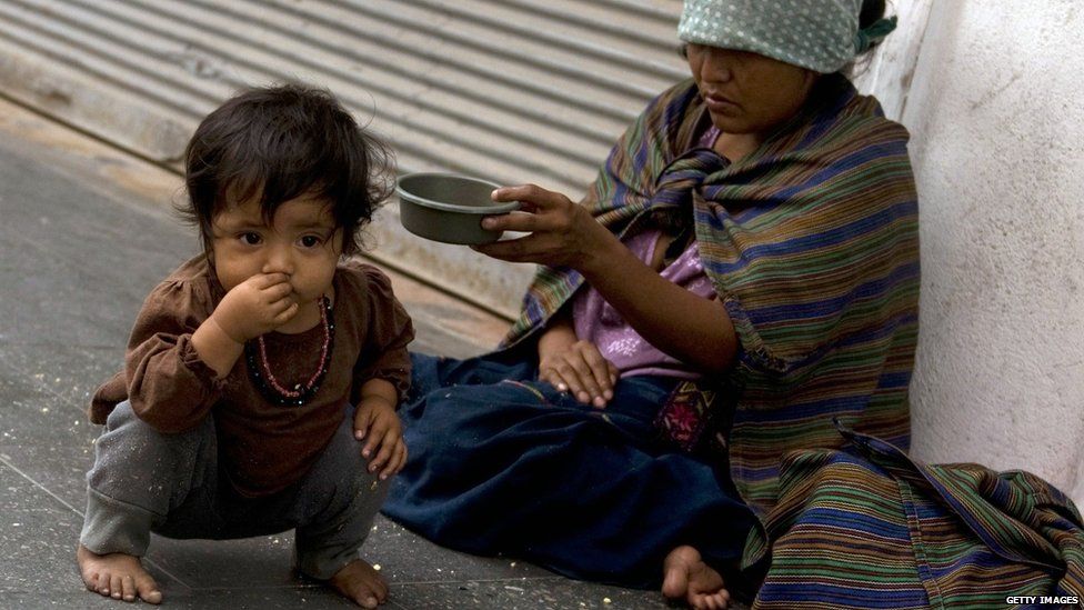 Small child with an adult who is begging on the street