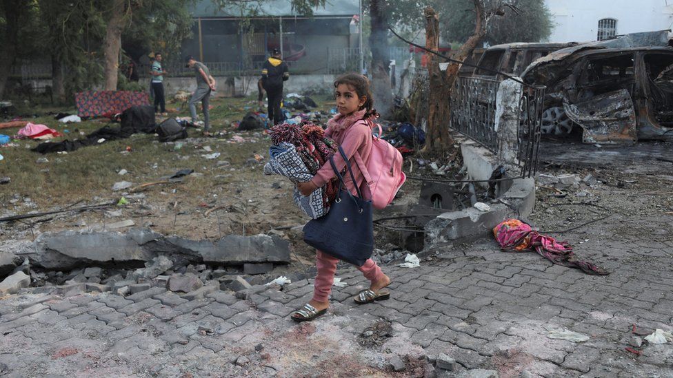 A girl walks through the courtyard of the Al-Ahli Arab hospital in Gaza City, where hundreds of people were reportedly killed by an explosion (18 October 2023)