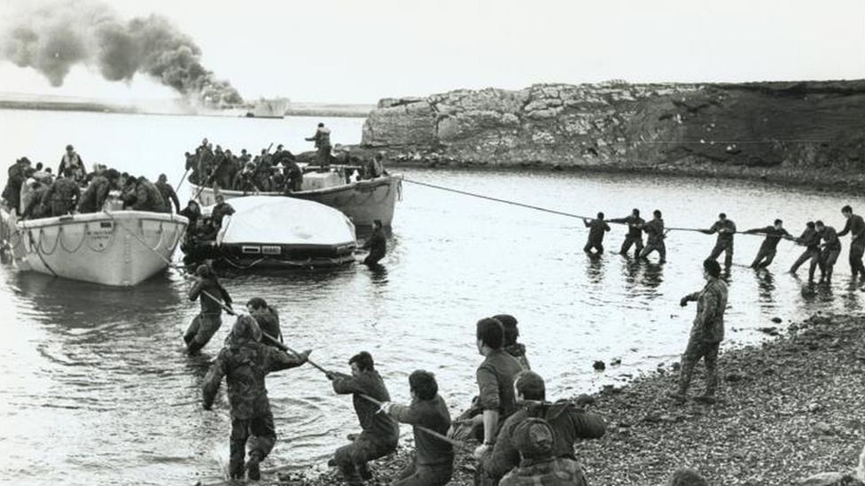 Survivors coming ashore from the bombed Sir Galahad