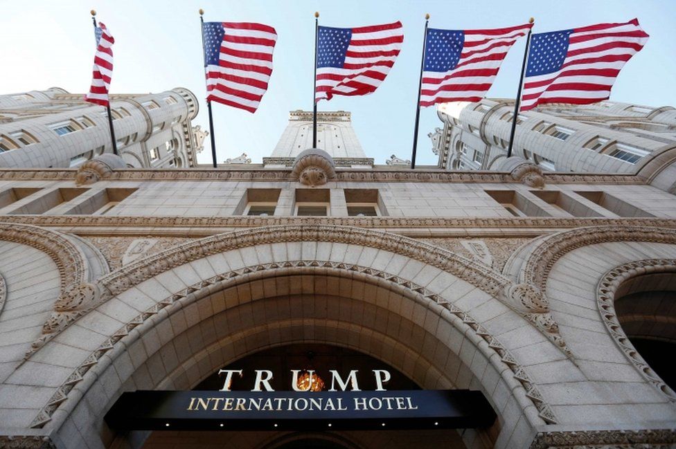 Flags fly above the entrance to the new Trump International Hotel on its opening day in Washington, DC, US, on 12 September, 2016.