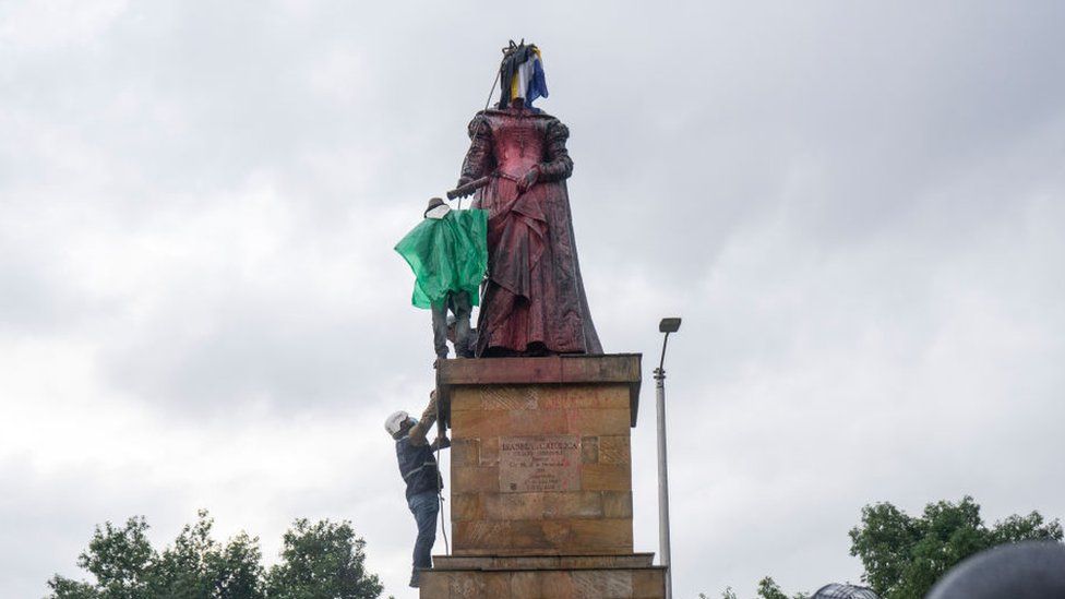 Misak indigenous stand in front of police officers as she protest next to the statue of queen Isabel of Spain on June 09, 2021 in Bogota, Colombia.