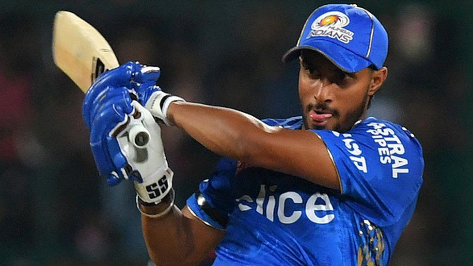 Mumbai Indians' Tilak Varma watches the ball after playing a shot during the IPL match between Royal Challengers Bangalore and Mumbai Indians on April 2