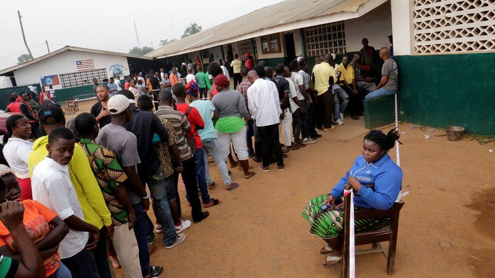 People wait to vote during the presidential election at a polling station in Monrovia, Liberia December 26, 2017