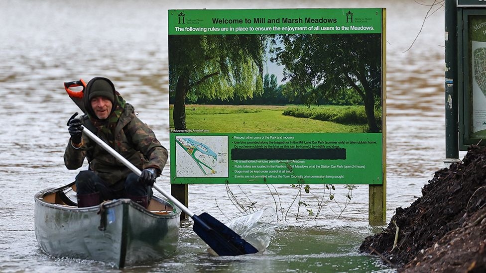 A man uses his kayak to cross flooded meadows in the aftermath of Storm Henk, at Henley-on-Thames on 5 January