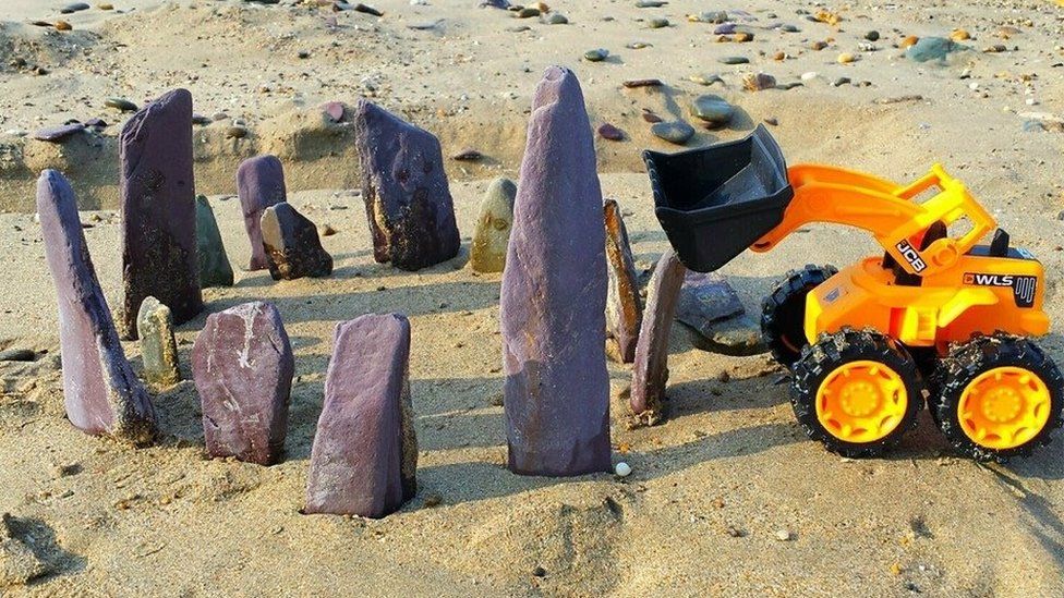 Toy digger and rocks