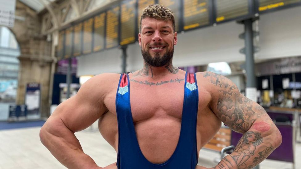 Gladiators Giant and Steel help passengers at Sheffield station BBC News