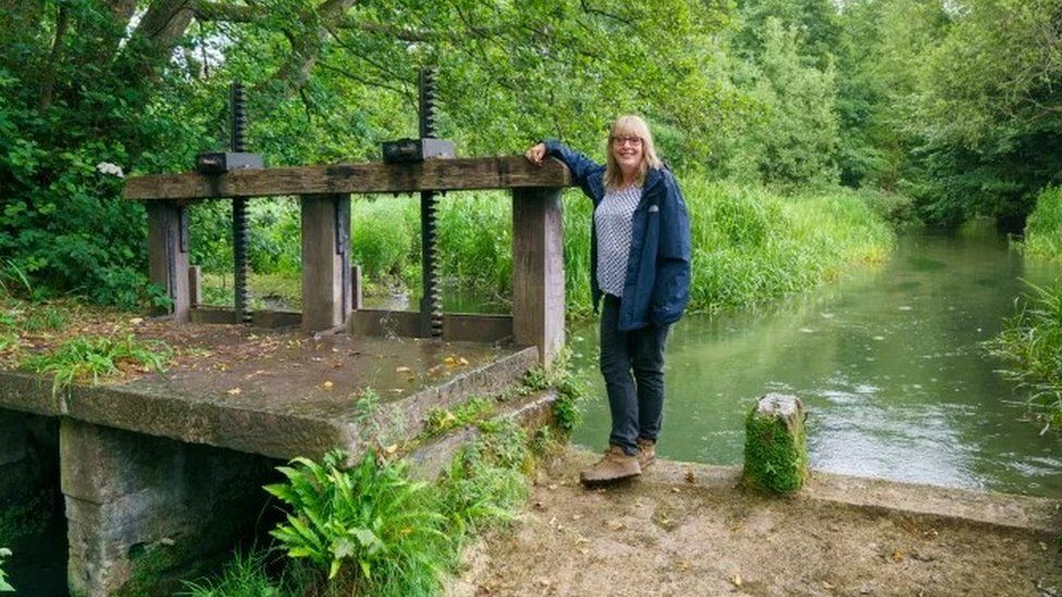 Clare Mahdiyone standing by the millpond