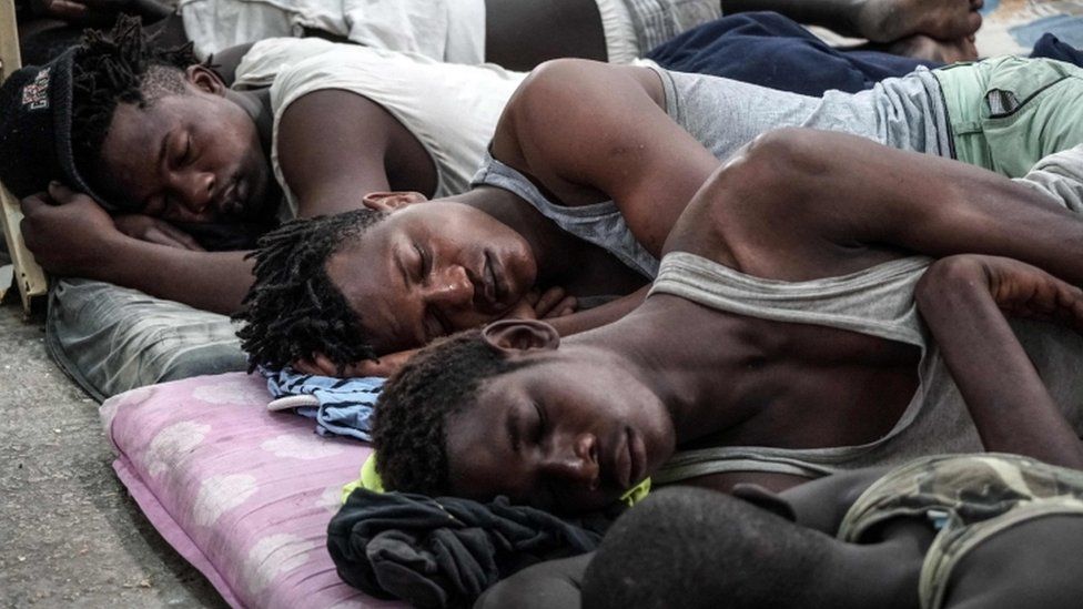 Illegal immigrants are seen sleeping at a detention centre in Libya