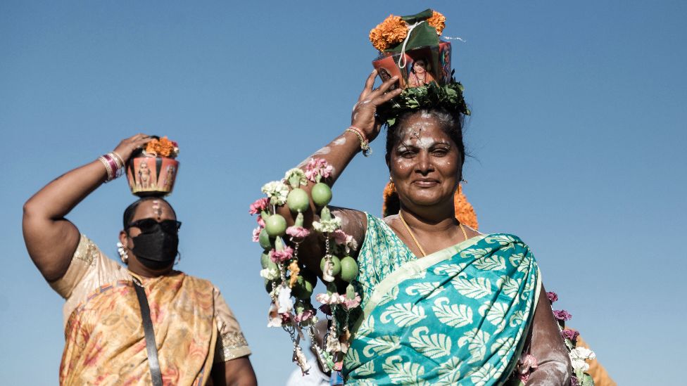Two Hindu worshippers with milk pots on their heads at the Ferndale grounds near the Suria Narayan temple in Phoenix township, South Africa - Tuesday 18 January 2022