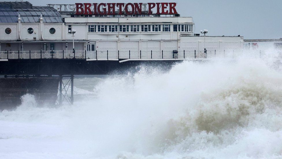 Huge waves crash onto the beach near Brighton pier.