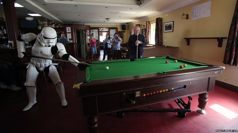 Star Wars fan John Joe McGettigan in stormtrooper costume playing pool in Farren's Pub