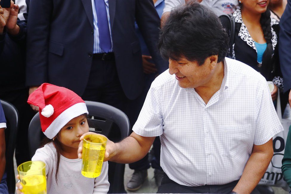 Exiled former president of Bolivia Evo Morales talks to a girl during a Christmas breakfast with members of the Bolivian community of Buenos Aires at Campo De Deportes del Colegio Nacional de Buenos Aires on 25 December 2019 in Buenos Aires, Argentina