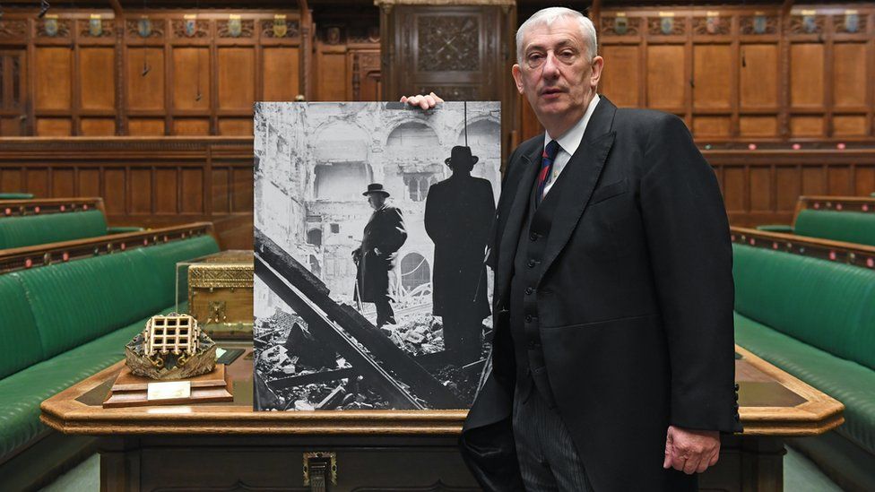 Sir Lindsay Hoyle holds a photo of Churchill surveying the wreckage
