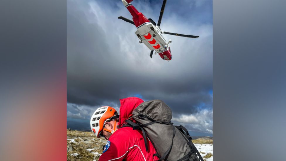 Llanberis Mountain Rescue Team member after being dropped off by Rescue 936 helicopter on the summit of Carnedd Ugain