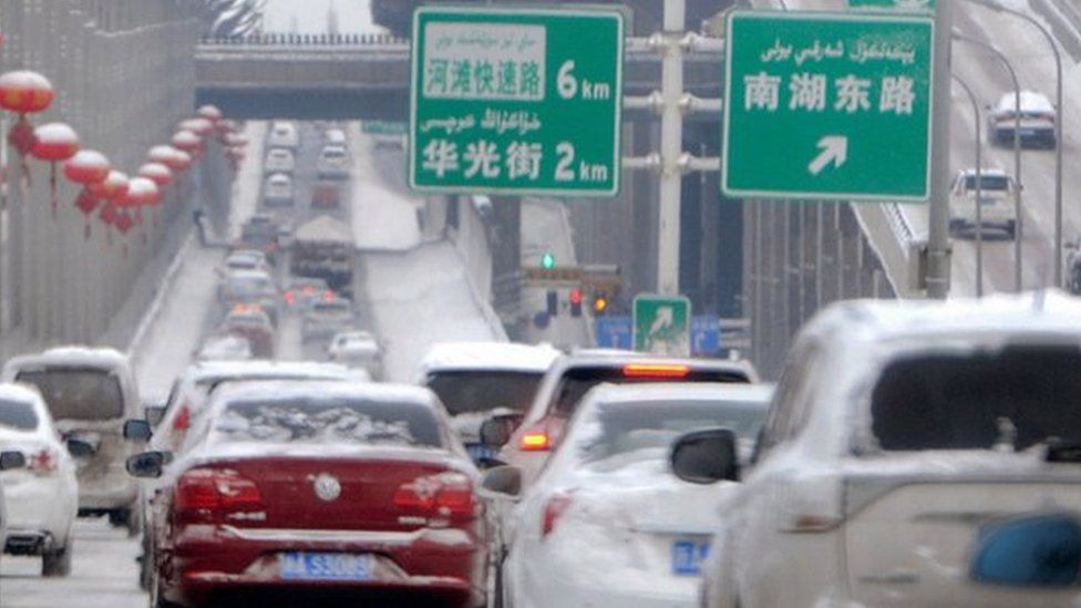Vehicles on a snow-covered road in Urumqi, capital of China's Xinjiang region