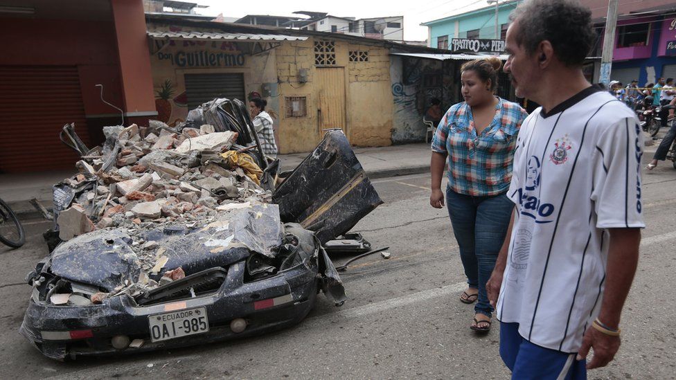 A car destroyed by rubble in Ecuador's earthquake