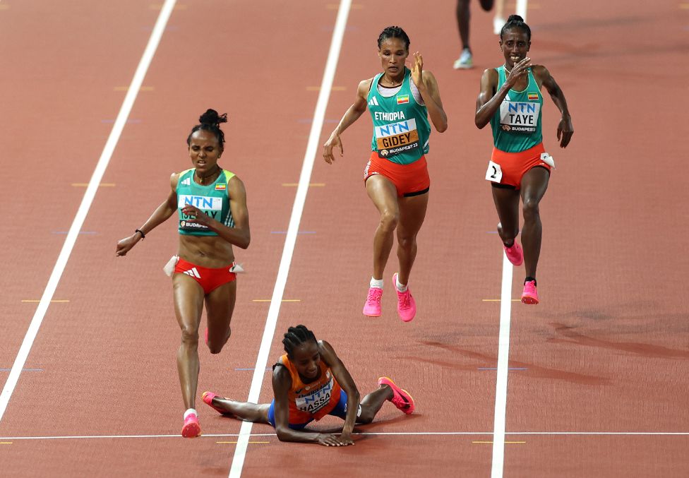 Netherlands' Sifan Hassan falls as Ethiopia's Gudaf Tsegay runs past her to win the women's 10,000m final