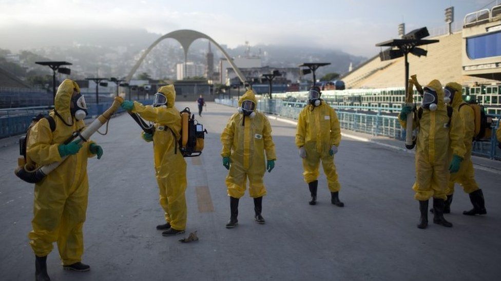 Health workers get ready to spray insecticide to combat mosquitoes that transmits the Zika virus in Rio de Janeiro, 26 January