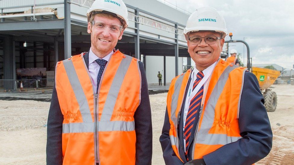 Industry Minister Lee Rowley on a tour of the site with Siemens' managing director Sanbit Banerjee