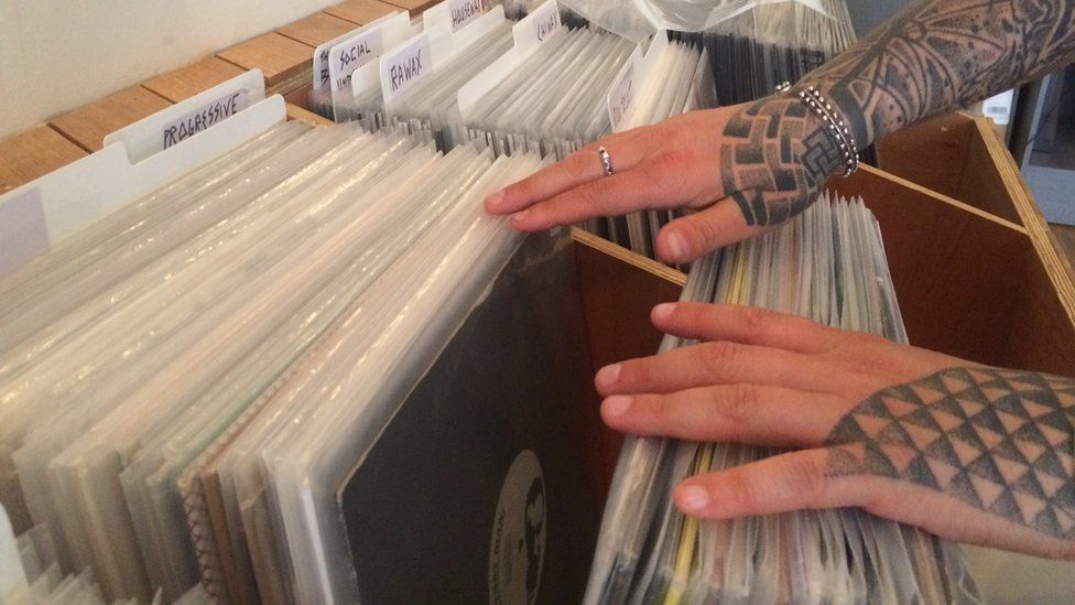 hands flick through records