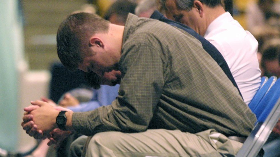 A student bows his head in prayer at Brigham Young university