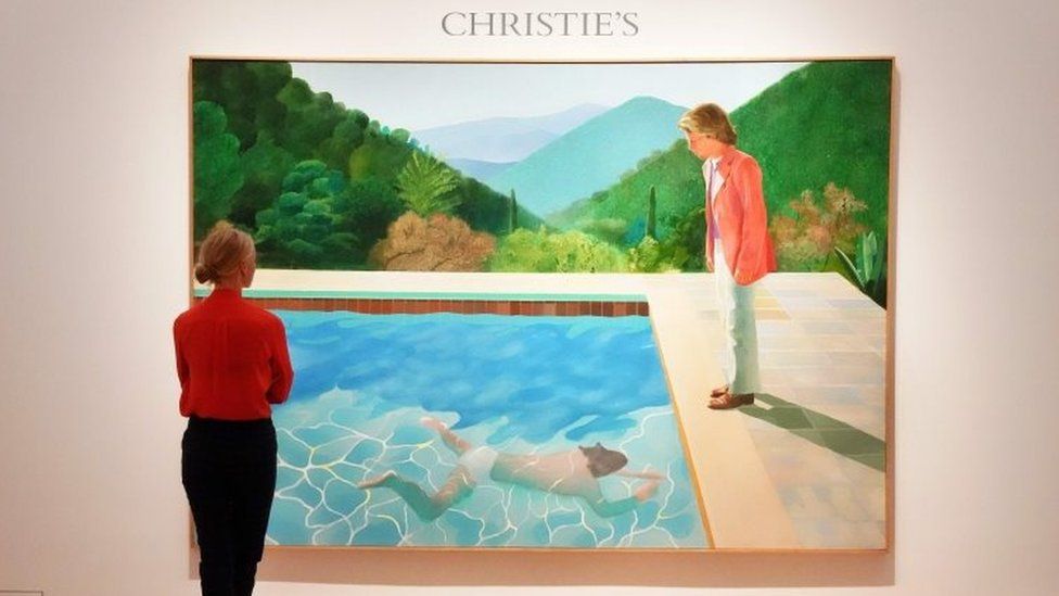 A woman looks at David Hockneys "Portrait of an Artist (Pool with Two Figures)" during a press preview on September 13, 2018 at Christie"s New York.