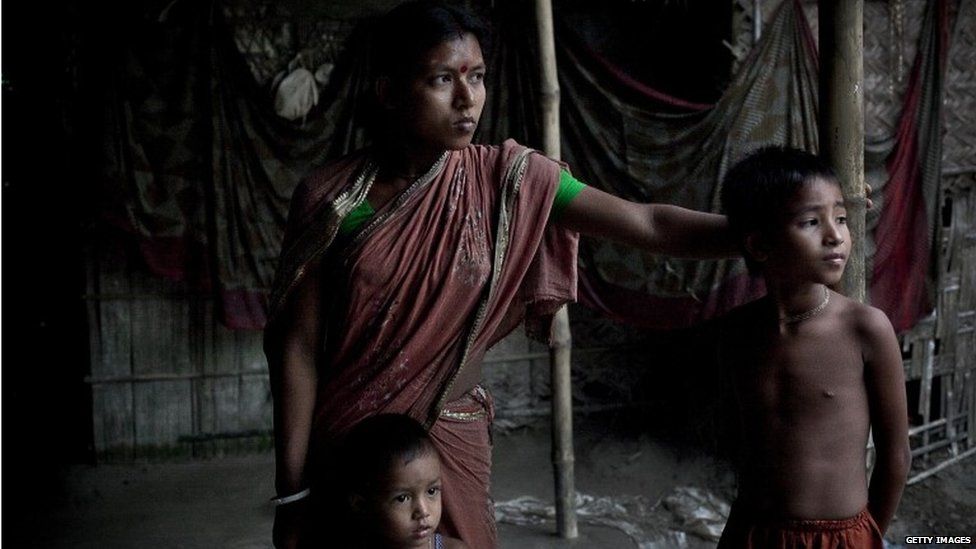 Gota Mari Indian enclave resident Bobita Rani stands outside her home July 10, 2015 in Lalmonirhat District, Bangladesh.