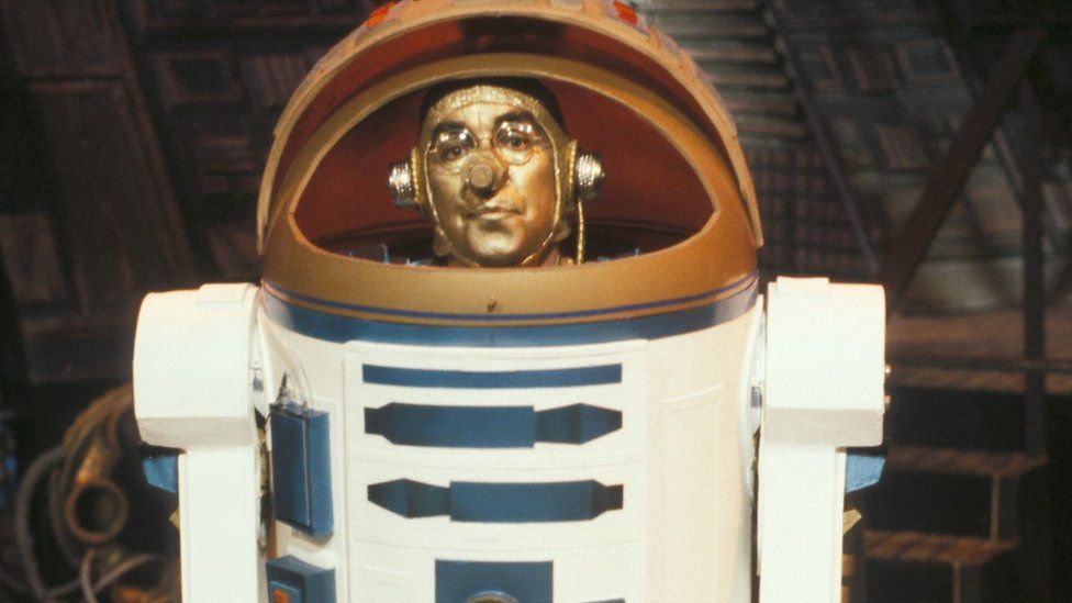 Costumes played a big role in The Two Ronnies, with the duo dressing up as Vikings, aliens, bikers - and here Corbett dressed as Star Wars robot R2D2