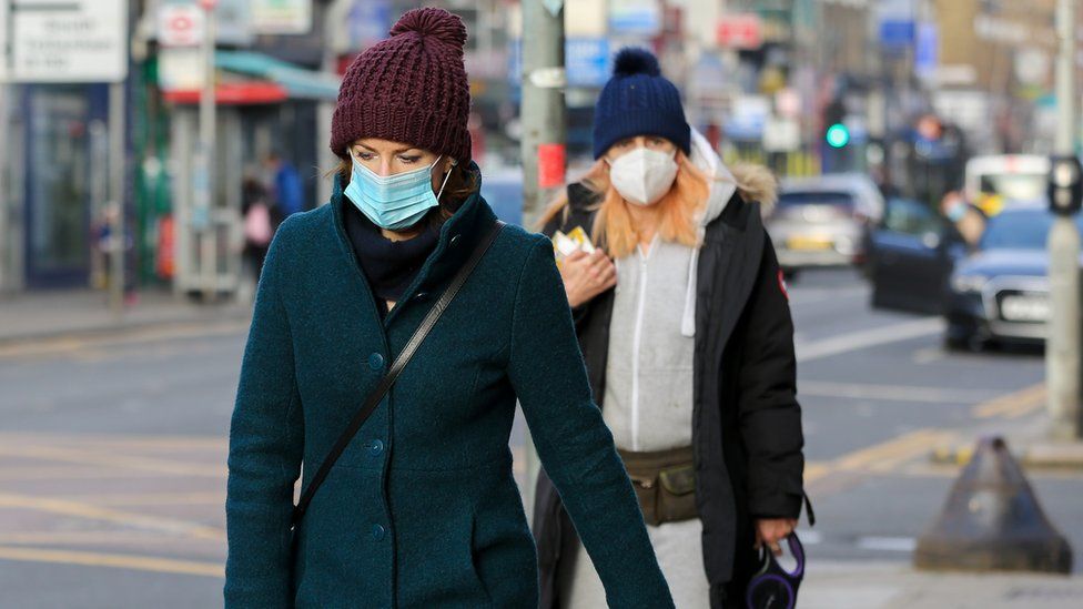 Woman in masks walk along a street in London on 21 January 2021